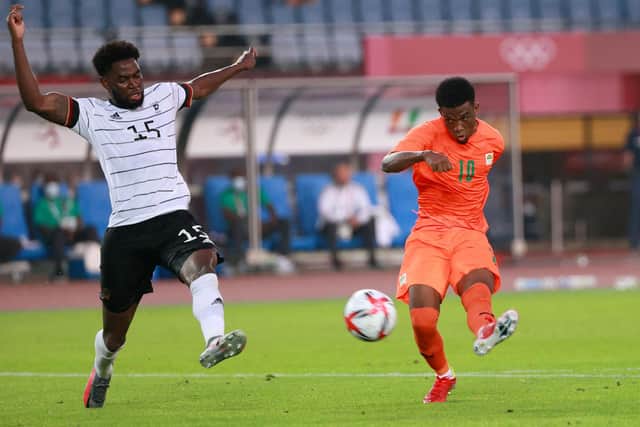Ivory Coast's forward Amad Diallo (R) shoots to the goal next to Germany's defender Jordan Torunarigha during the Tokyo 2020 Olympic Games men's group D first round football match between Germany and Ivory Coast at the Miyagi Stadium in Miyagi on July 28, 2021. (Photo by Kohei CHIBAHARA / AFP) (Photo by KOHEI CHIBAHARA/AFP via Getty Images)