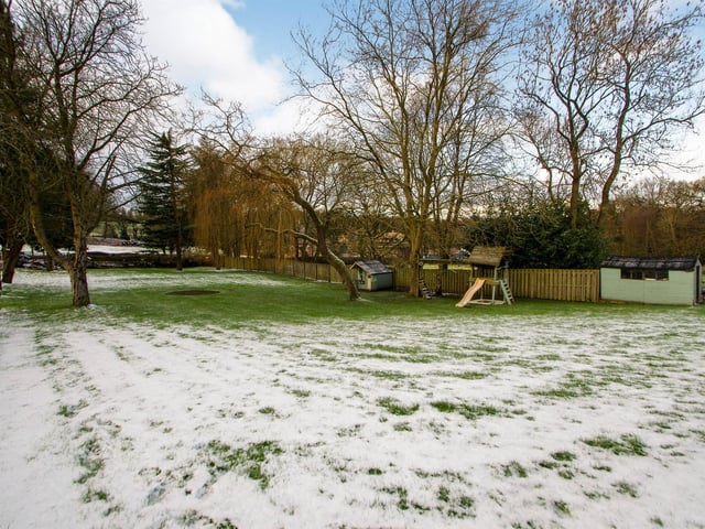 Immediately to the front of the property there is a generous garden which has a variety of mature trees.