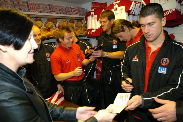Sheffield  United players including Nick Montgomery, right, sign autographs for fans before going into the Christmas party at Bramall Lane on December 18, 2005