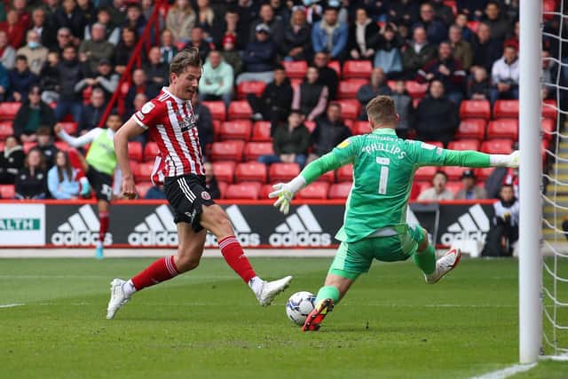 Dillon Phillips of Cardiff City saves at the feet of Sander Berge of Sheffield United: Simon Bellis / Sportimage