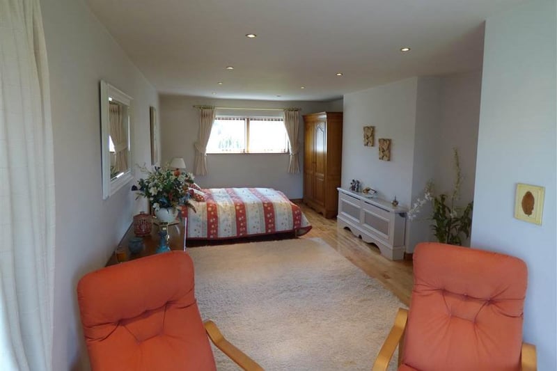 Spacious fourth bedroom with seating area.