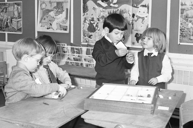 It's time to get down to some work and these children at Hill View Infants School are enjoying a craft class in September, 1974 .