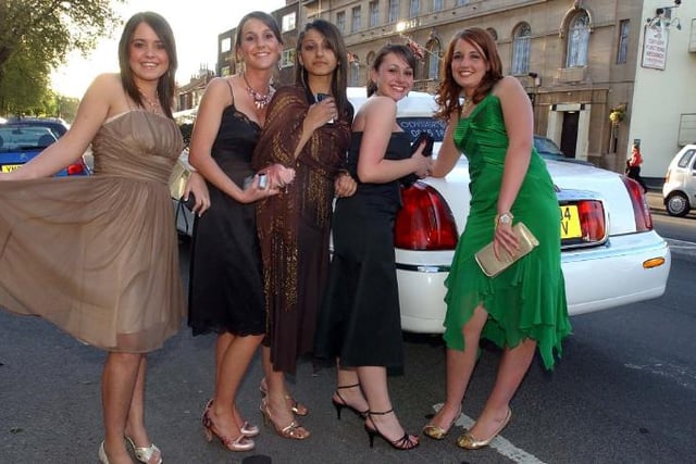 Girls posing in front of a limousine in 2005.