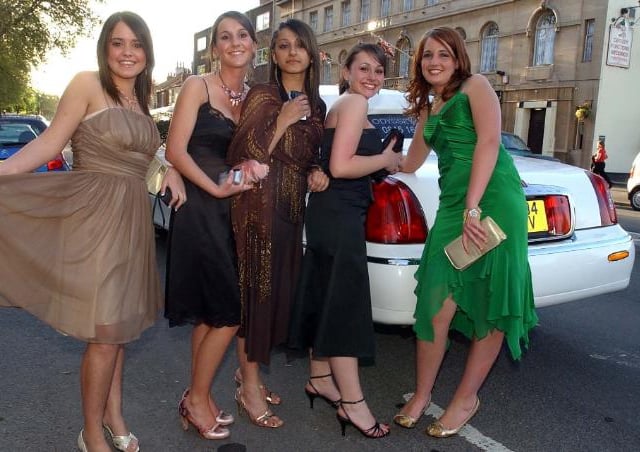 Girls posing in front of a limousine in 2005.