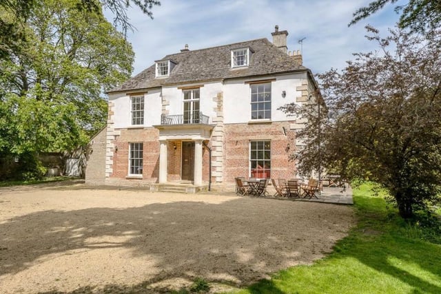 This Grade II listed village home in Castor sits just five miles west of Peterborough amid the rolling countryside, and benefits from 14 bedrooms, an annexe, stable block, a cellar, and mature grounds measuring around 1.6 acres. Price: £1,600,000.