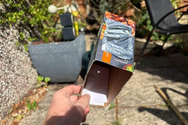 A homemade pinhole projector made using a cereal box can show the shadow of the moon as it passes in front of the sun.