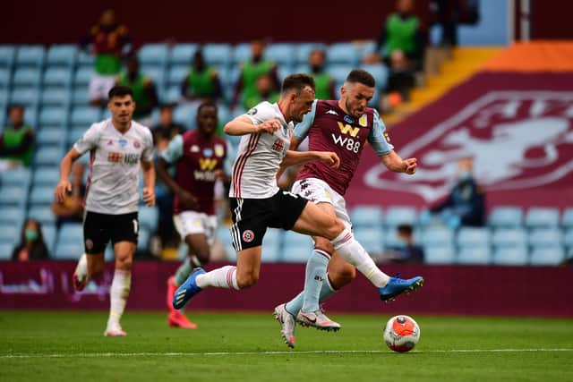 John McGinn of Aston Villa battles for possession with Jack Robinson of Sheffield United: Shaun Botterill/Getty Images