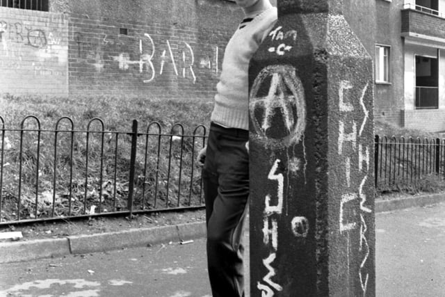 Run-down, neglected and covered in graffiti, the flats at Pendeen Crescent (known as Scotland's Street of Shame) in Glasgow, November 1980. Boy is unidentified.