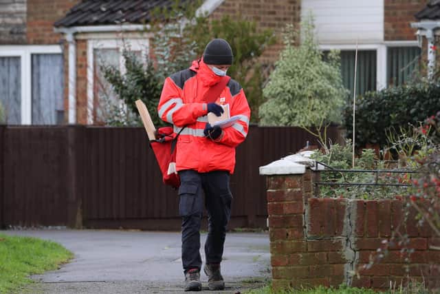 A Royal Mail delivery worker in Ashford, Kent, during England's third national lockdown to curb the spread of coronavirus.