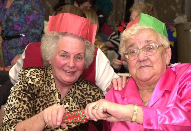 Esme Monday and Betty Lincoln pulling a cracker in 2001.