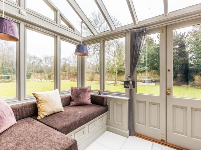 The perfect vantage point to take in views over the rear gardens with doors leading out onto a patio area. Built in seating with storage below.