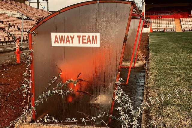 The away team benches are dishevelled and overgrown