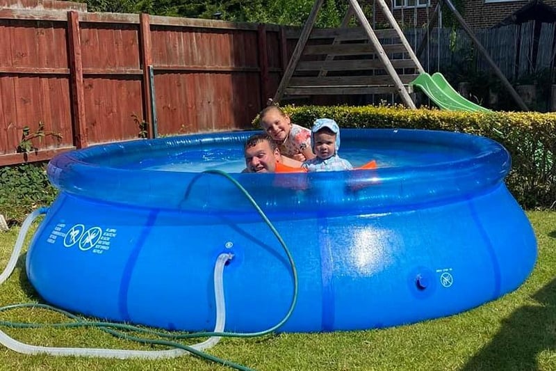 A family enjoying a massive paddling pool.