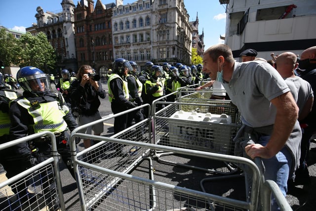 Police are confronted by protesters as tensions rise. Jonathan Brady/PA Wire