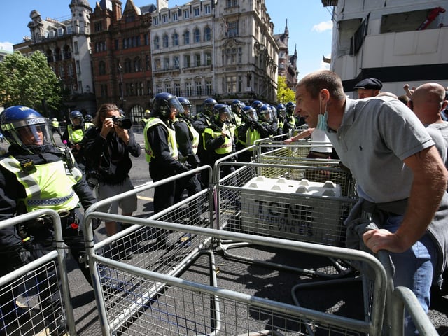 Police are confronted by protesters as tensions rise. Jonathan Brady/PA Wire