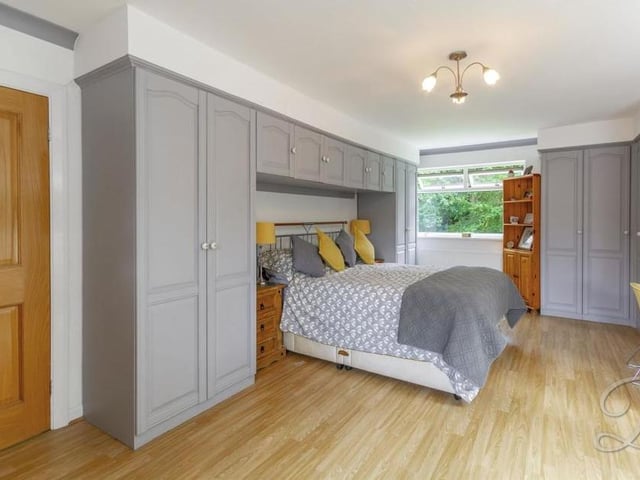 The first bedroom is a great size. It boasts laminate flooring, fitted wardrobes and triple-aspect windows.