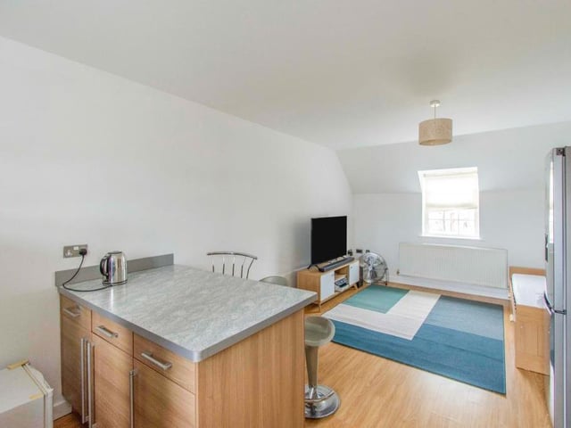 Open Plan Kitchen Living Diner - A spacious kitchen area which is fitted with a range of wall and base units with coordinating work surfaces incorporating the sink and drainer with mixer tap. The kitchen has a four ring electric hob with a cooker hood above, an electric oven and grill, an integrated fridge and freezer and an integrated dishwasher. There is laminate flooring, a central heating radiator, two spotlights and a focal breakfast bar ideal for entertaining. With a rear facing double glazed window and open walk through towards the living room. The living area has an additional central heating radiator, an area for a dining table and chairs and a front facing double glazed window.