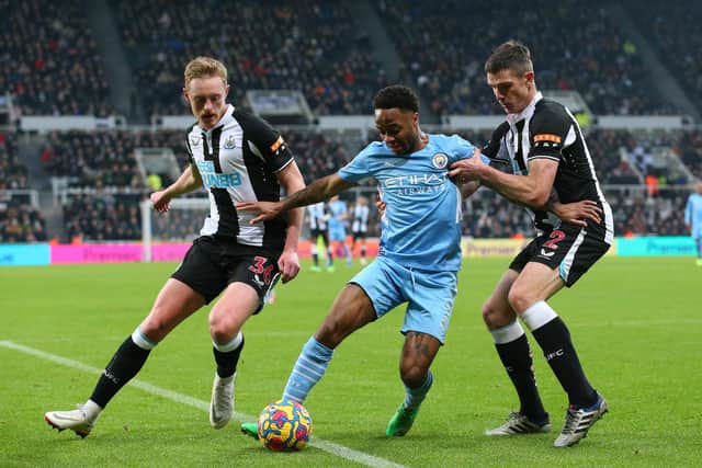 Raheem Sterling of Manchester City holds off a challenge from Ciaran Clark and Sean Longstaff of Newcastle United (Alex Livesey/Getty Images)