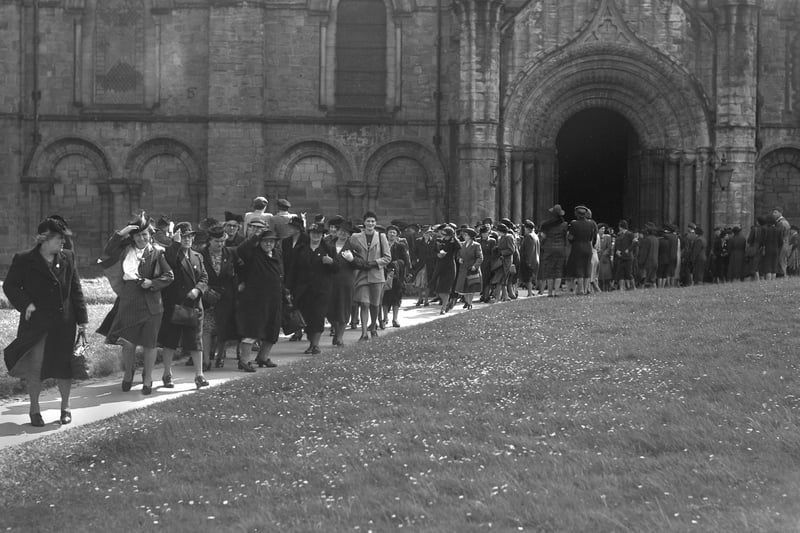 The scene outside Durham Cathedral after the special service of thanksgiving and commemoration for the Women's Voluntary Service in the North Eastern Region.  The photograph shows Sunderland members on parade in 1945.