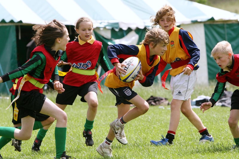 Action from the match between Bishop Purseglove School(green and black stripes) and Longstone A at the Tag Rugby Tournament, Cromford Meadows.