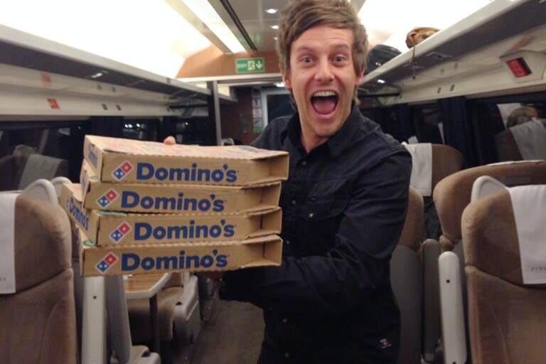 Comedian Chris Ramsey with the pizza that was successfully delivered to a train at Doncaster Station in 2014