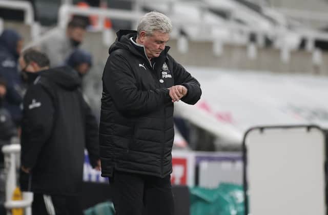 Steve Bruce, manager of Newcastle United, checks his watch during the Premier League game against Leeds United at St. James Park.