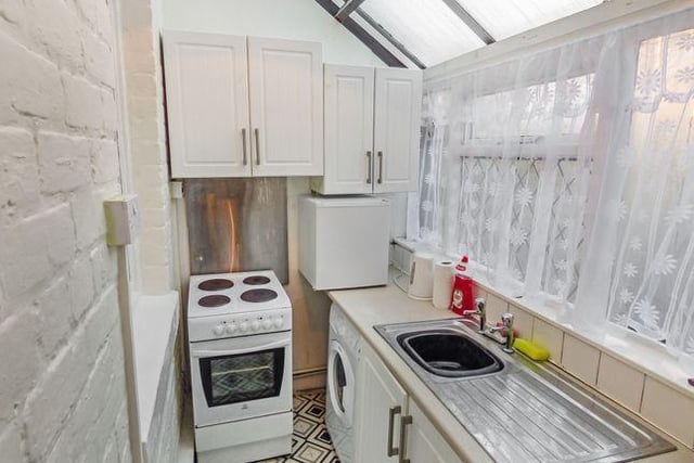 The kitchen is situated in a single glazed lean-to style conservatory. It features a mix of wall and base units with a work surface and single drainer stainless steel sink unit with dual taps. The kitchen is plumbed for a washing machine and has an electric cooker point with part tiled walls.