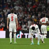 John Stones, Jadon Sancho and Harry Maguire look dejected after the Euro 2020 final between Italy and England. (Photo by Paul Ellis - Pool/Getty Images)