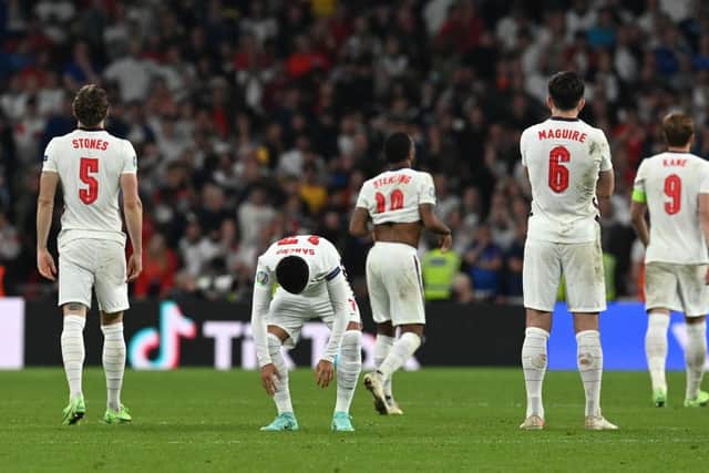 John Stones, Jadon Sancho and Harry Maguire look dejected after the Euro 2020 final between Italy and England. (Photo by Paul Ellis - Pool/Getty Images)