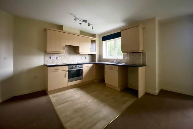 The kitchen area is compact, but boasts a range of high-level and low-level cupboards with worktops over, a sink basin with mixer taps and a linoleum floor. There is a window to the side of the flat.