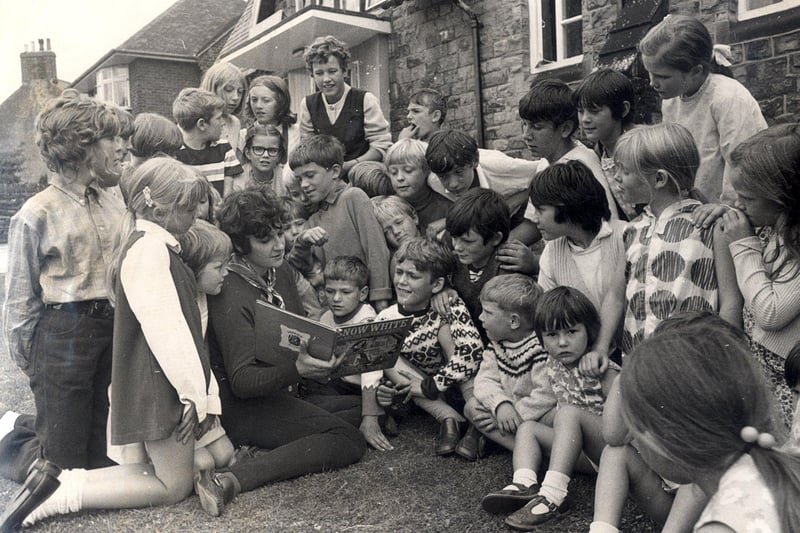 Mrs Margaret Andrews reads to children  at the Eagle Youth Club, Newbold ,Chesterfield, during a play scheme on August 9th 1971