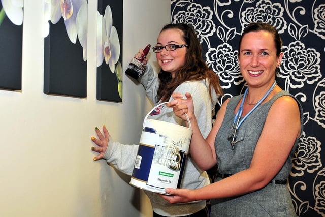 Hartlepool and District Hospice Doctor Amy Johnstone holds the tin of paint for Gemma Docherty from National Citizen Service as she finishes off one of the walls in a 2011 project at Alice House.