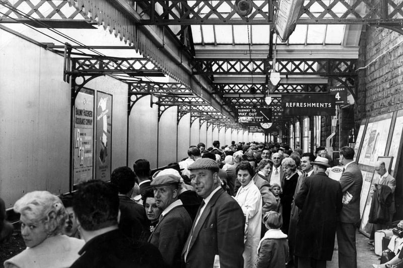 Holidaymakers wait for their train at Sheffield Victoria Station in 1962