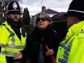 Sheffield trees campaigner Andrea Stone being arrested for blowing a toy horn at a protest on Rivelin Valley Road, Sheffield in March 2018. A new film, The Felling, which documents the battle to save city street trees, premieres at Sheffield City Hall on March 20