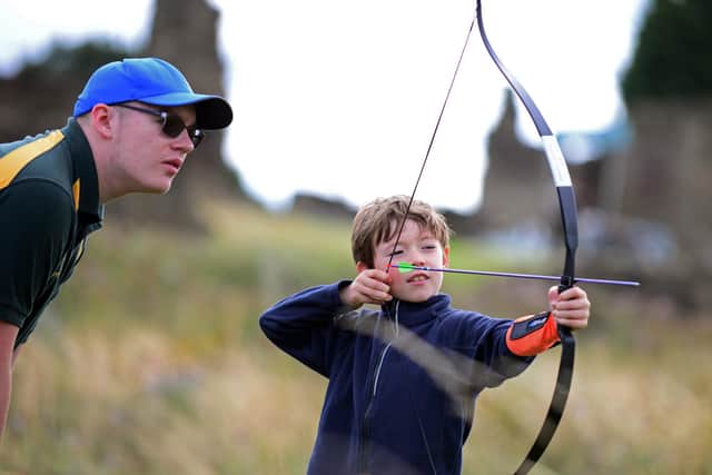 Hamish Sheard, eight, learning some archery skills from Riley Lightfoot of Danum Archers at Manor Lodge, Sheffield in 2019