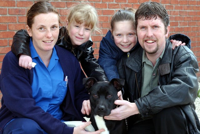 Allan Stanley and his two daughters April Stanley, 7 and Abigail Stanley, 11 re-united with their pet dog George at the PDSA petaid hospital, Newhall Road, Atlas, Sheffield after his identity came up after he was tagged. Vet Nurse Natalie Cowley, pictured with the happy family in 2004.