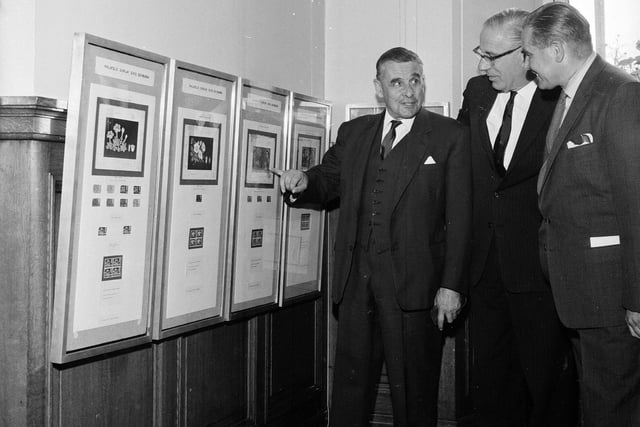 Mr Vallance points out a detail on one of the 'Botanical Congress' stamp issues to Kew director Sir George Taylor and Scottish Philatelic Society president at the Botanics in August 1964.