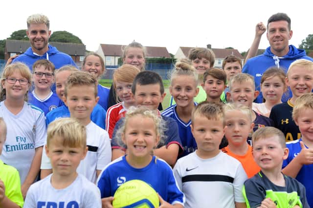 Here is a scene from the Soccer School summer scheme visit by HUFC players Nicky Deverdics and Carl Magnay. Who can you spot in this 2017 photo?