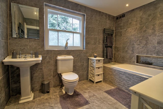 Fully tiled with underfloor heating, comprising of bath, WC, wash basin, wall mounted towel rail and shaver points.