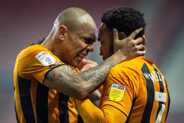 Josh Magennis - left - has joined Wigan Athletic from Hull City.
