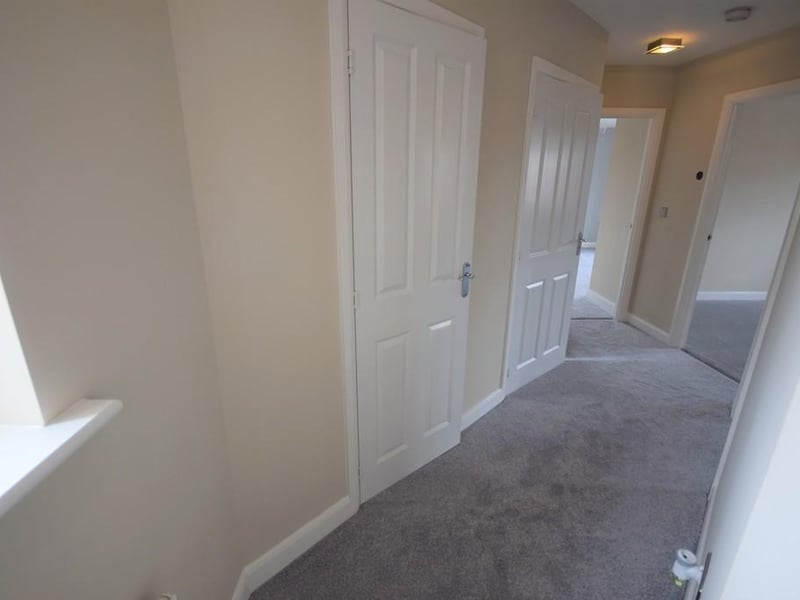 A bright entrance hallway having two handy storage cupboards, UPVC double glazed window, Honeywell heating control, socket point, BT Openreach socket and internal doors to the main rooms.