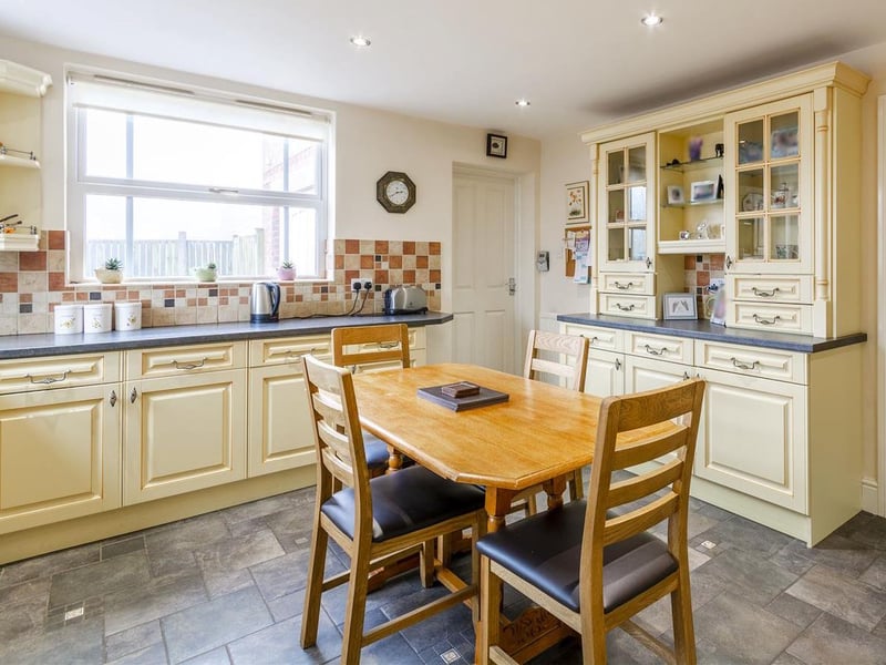 Complete with a range of traditional units and cabinets with work surface over and inset sink and drainer.