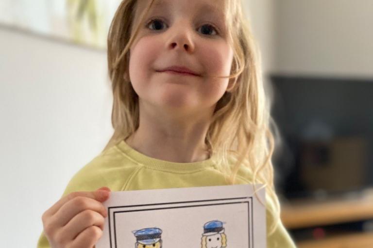 A High Oakham Primary School pupil shows off her art work for police officers.