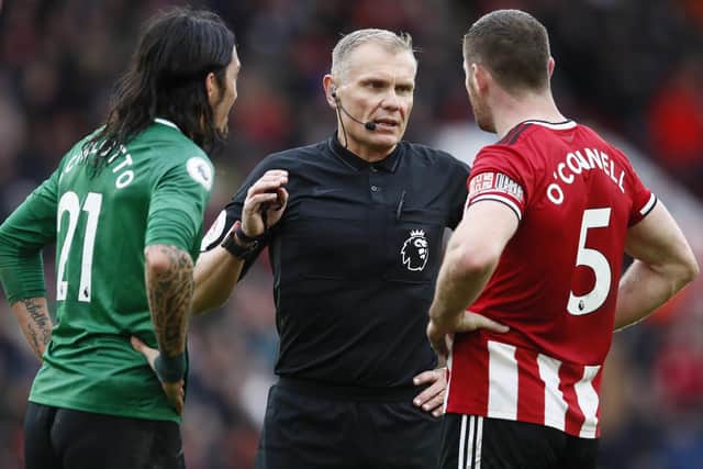 Referee Graham Scott talks to Ezequiel Schelotto of Brighton and Jack O'Connell of Sheffield United last season: Simon Bellis/Sportimage