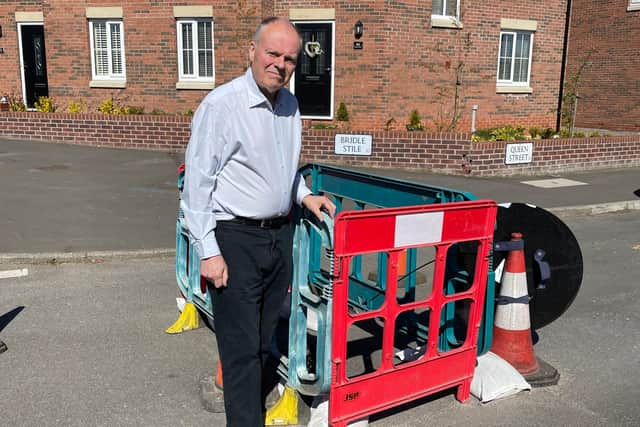 MP Clive Betts pictured next to the hole in Queen Street in Mosborough.
