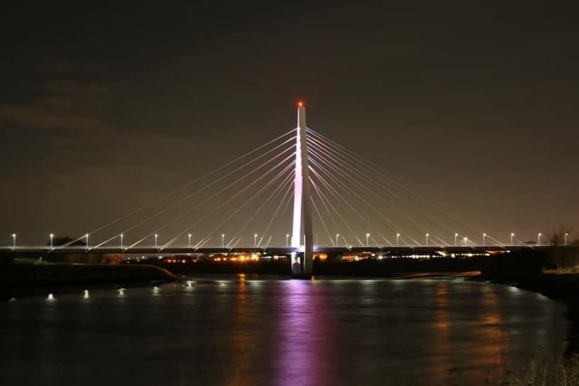 A peaceful view of the Northern Spire bridge over the river.