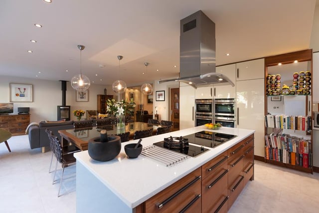 Here's another look at the kitchen - it has appliances by Neff, including a five-ring induction hob and a gas Wok burner with an extractor hood over. There are also two fan assisted ovens and an integrated wine cooler.