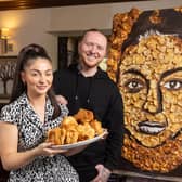 Pub landlady Jamie Wilson and artist Nathan Wyburn with the Yorkshire pudding portrait he created for her (pic: Phil Tragen / Brazen PR / SWNS)