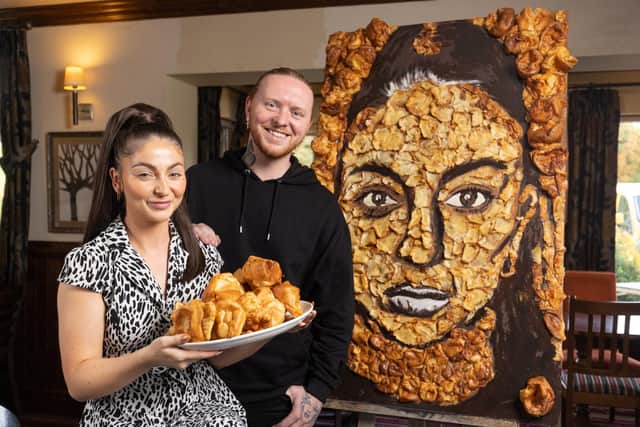 Pub landlady Jamie Wilson and artist Nathan Wyburn with the Yorkshire pudding portrait he created for her (pic: Phil Tragen / Brazen PR / SWNS)