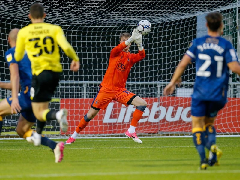 Mansfield Town goalkeeper George Shelvey blocks a shot.